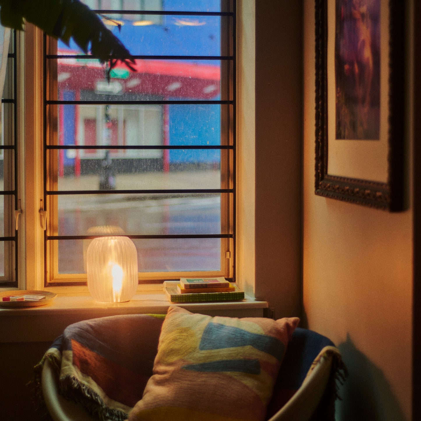 Wooj Design Allium Lamp with clear glass shade and modern floral-inspired design on a wooden surface.