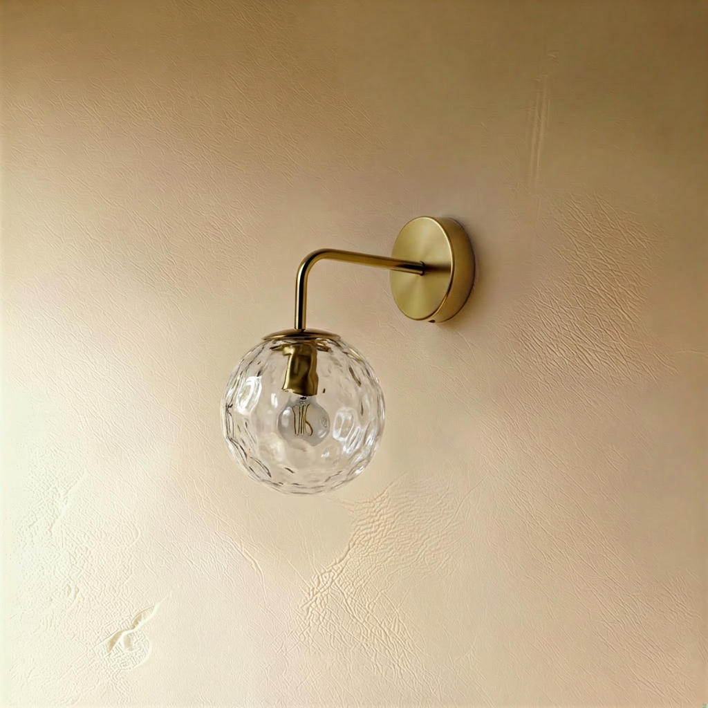 Black Sfera wall lamp by Residence Supply mounted on a plain background, showcasing its sleek, modern design.