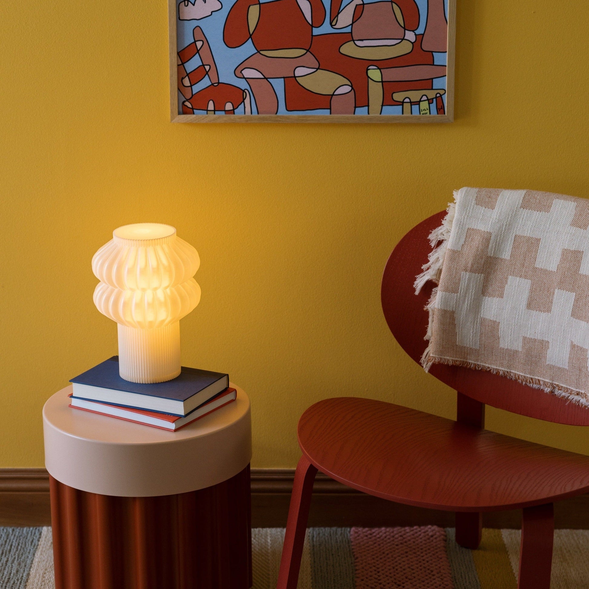 Terra Labs Oppi table lamp with a sleek, modern design, featuring a white cylindrical lampshade and wooden base.