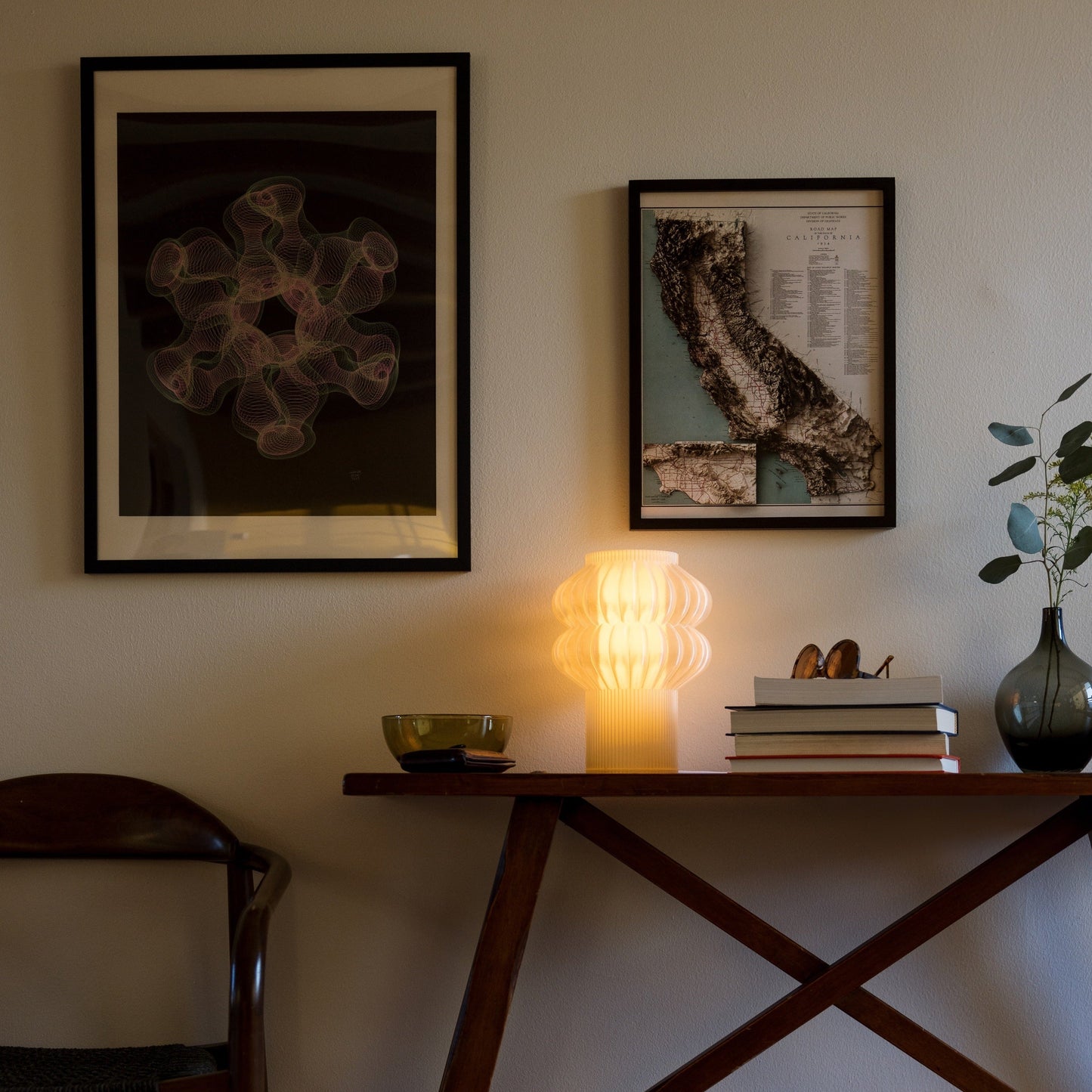 Oppi Table Lamp by Terra Labs with a modern, minimalist design and warm lighting, shown on a sleek table surface.