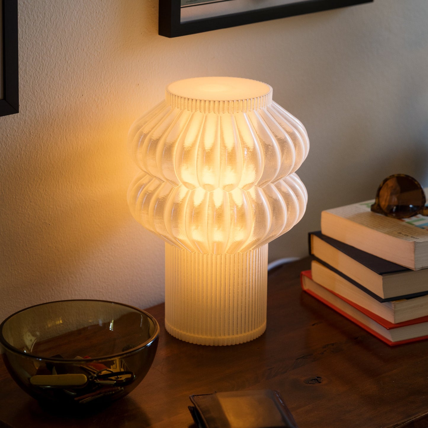 Terrra Labs Oppi table lamp with a modern, minimalist design featuring a white ceramic base and a soft fabric lampshade.