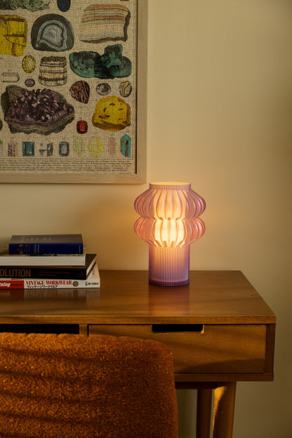 Terra Labs Oppi Table Lamp with a sleek modern design and soft lighting, placed on a wooden side table.