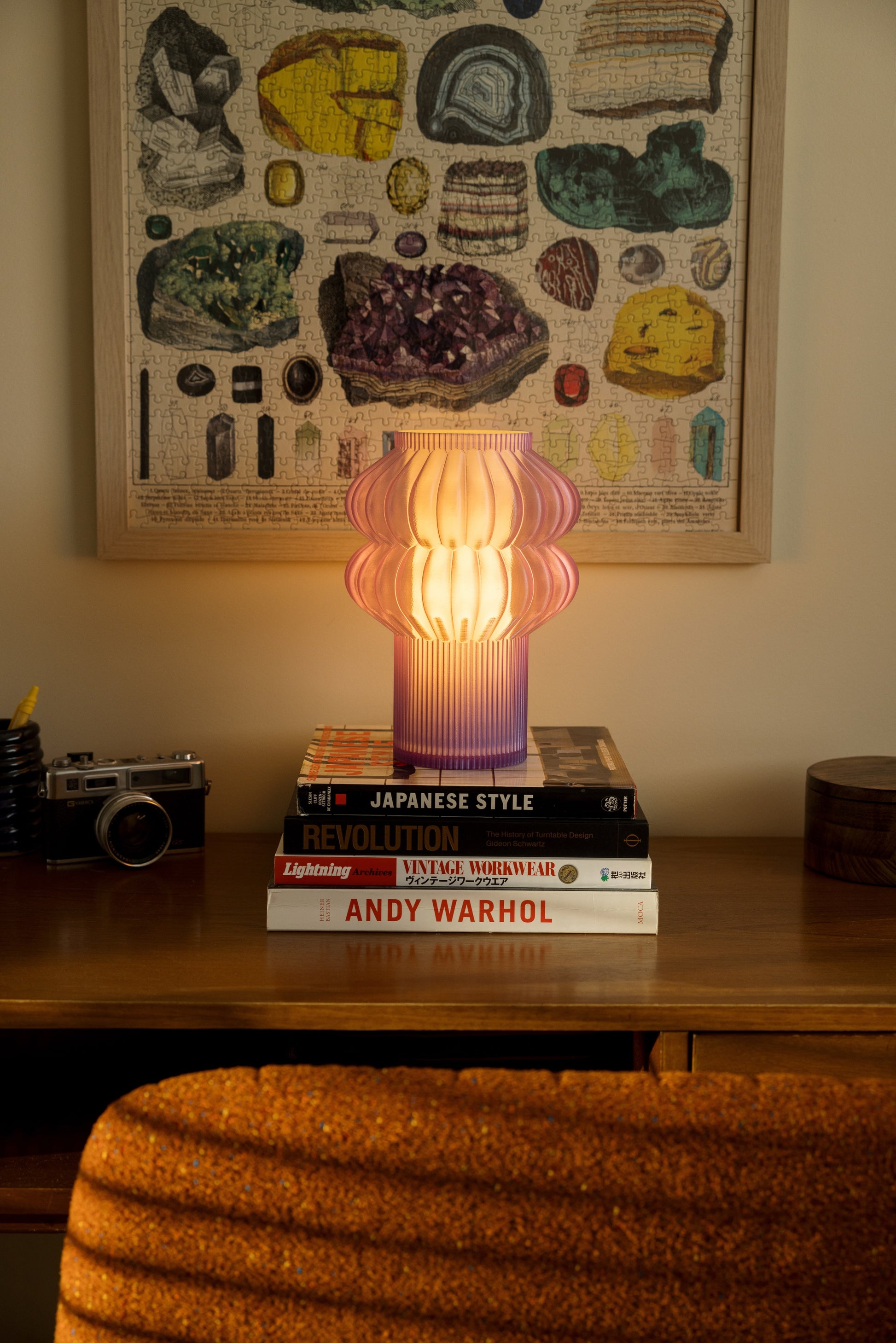 Terra Labs Oppi table lamp with a sleek, modern design and warm light, placed on a wooden side table.