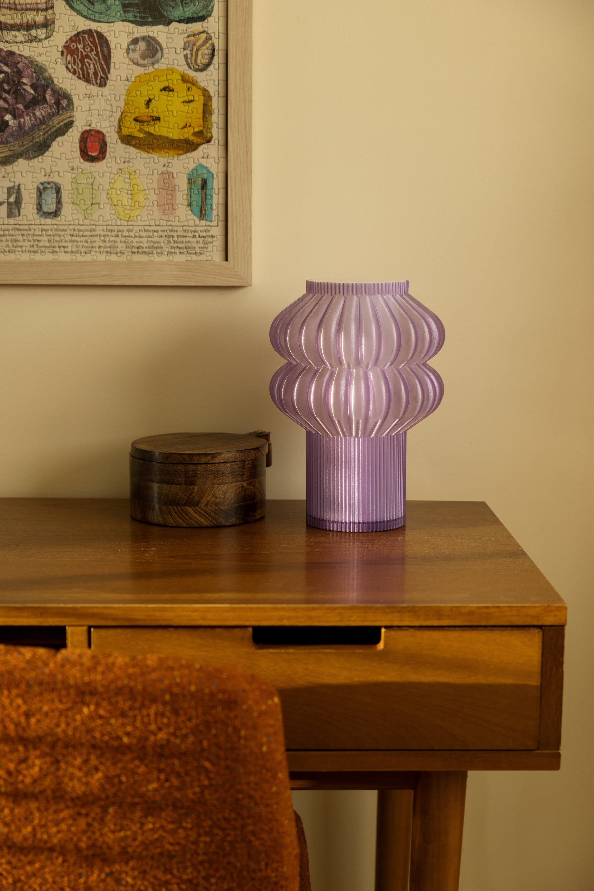 Terra Labs Oppi table lamp with a sleek, modern design and soft ambient lighting on a wooden surface.
