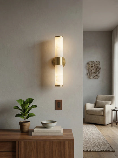 Alabaster Lampatron cylindrical wall lamp by korewolamp, showcasing a sleek white alabaster fixture on a wall.