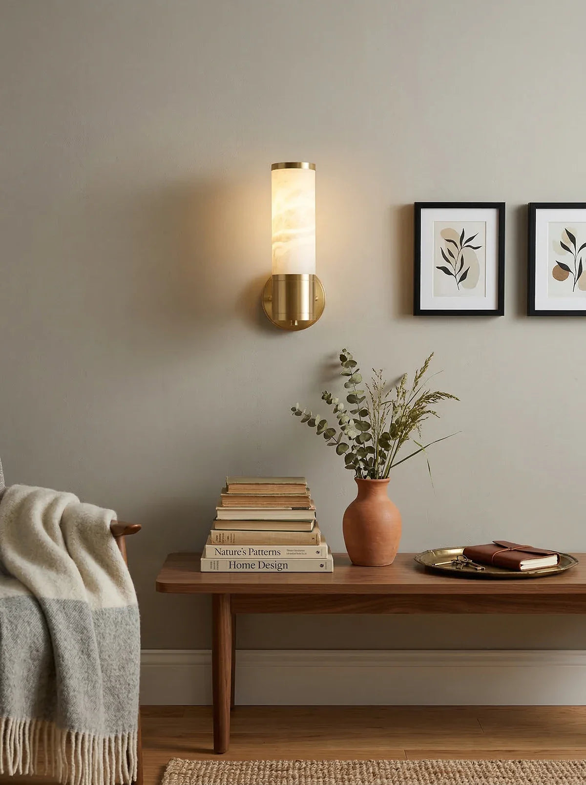 Alabaster Lampatron cylindrical wall lamp by korewolamp mounted on a wall, showcasing its smooth alabaster finish and modern design.