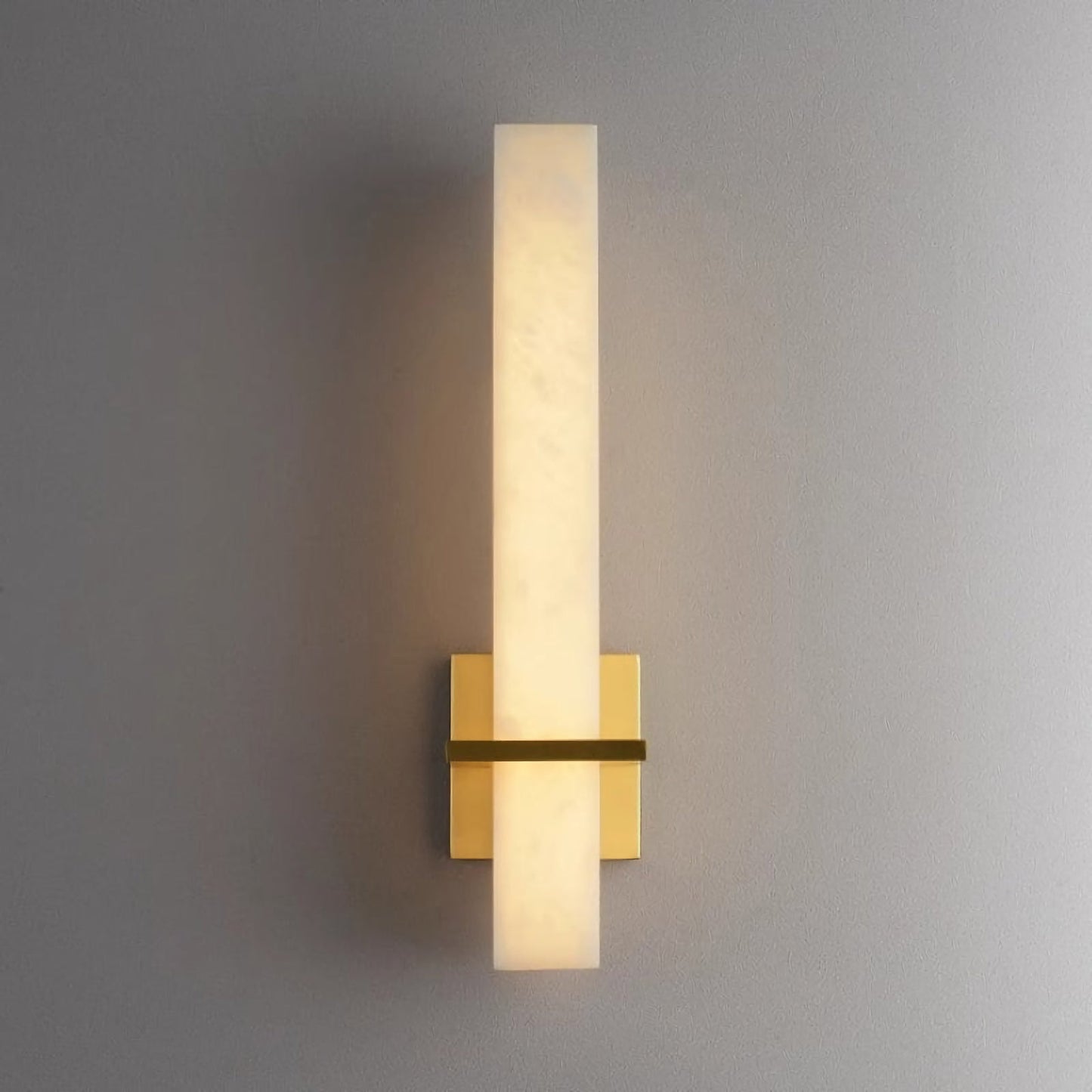 Alabaster Milan wall lamp by Korewolamp featuring a sleek design and warm glow, mounted on a wall with a modern aesthetic.