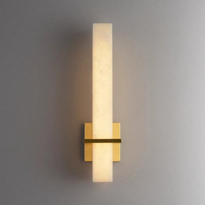 Alabaster Milan wall lamp by Korewolamp featuring a sleek design and warm glow, mounted on a wall with a modern aesthetic.