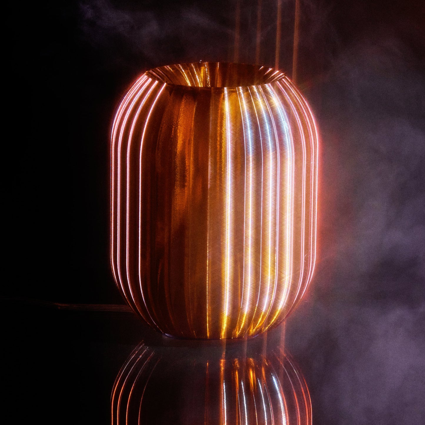 Allium Lamp by Wooj Design with amber-colored glass and modern design, staged on a wooden surface.