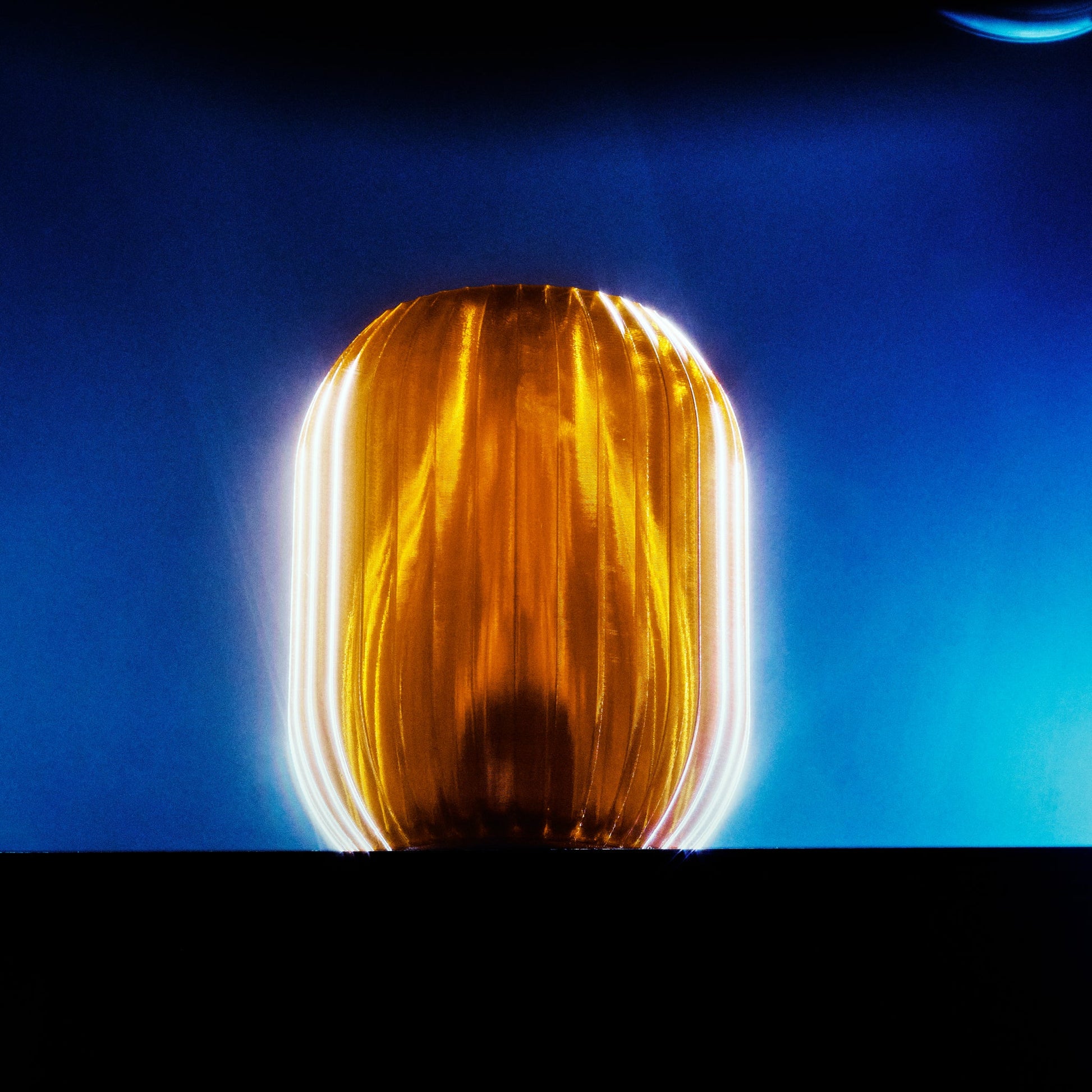 Wooj Design Allium Lamp with warm amber glow, featuring a modern, sculptural floral-inspired design for stylish home lighting.