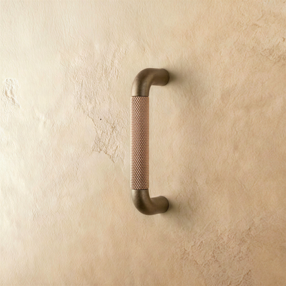 A brown Alyma knob and pull bar for cabinets, featuring a sleek, modern design from Residence Supply's cabinet hardware collection.