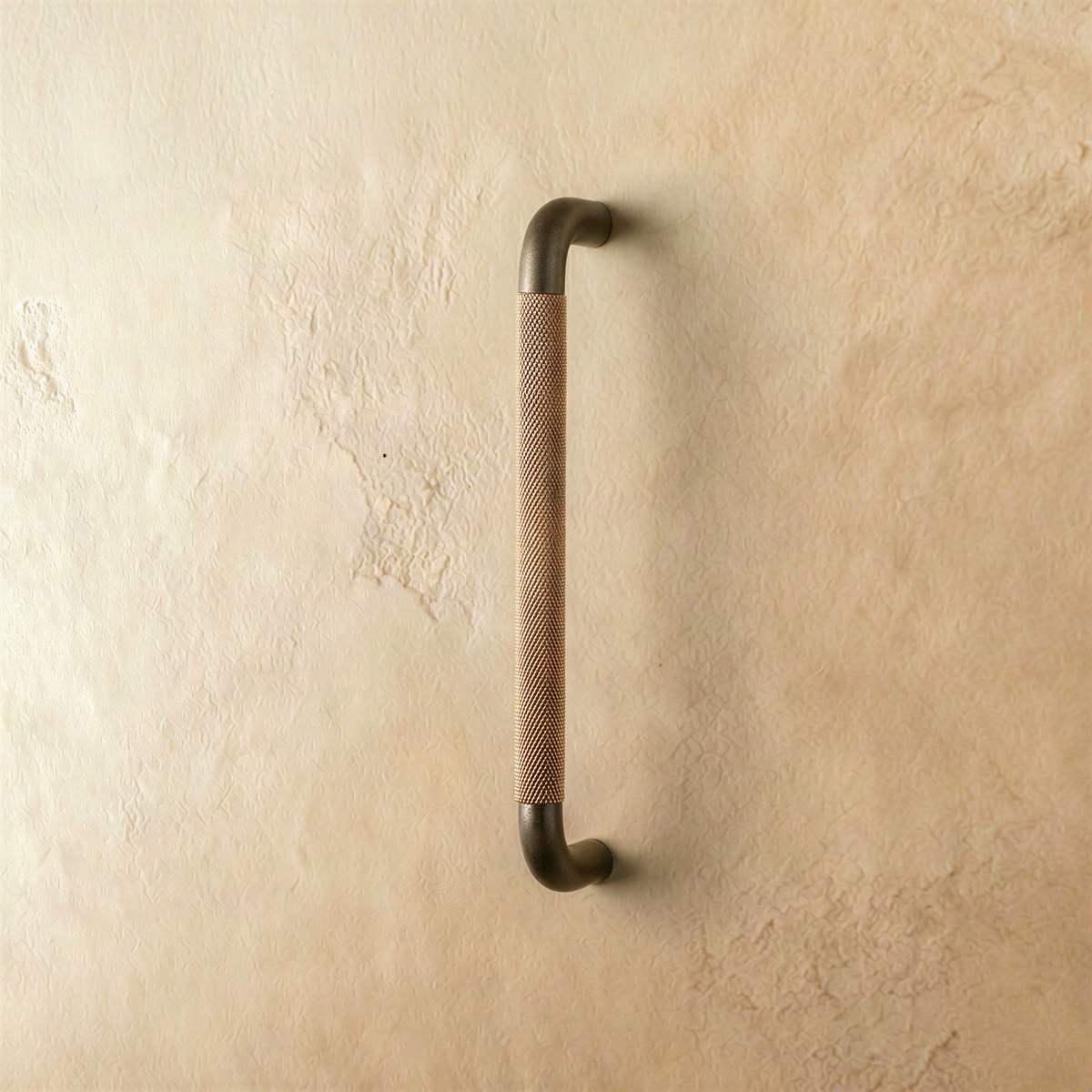 A brown Alyma knob and pull bar from Residence Supply, cabinet hardware for kitchen or bathroom cabinets.