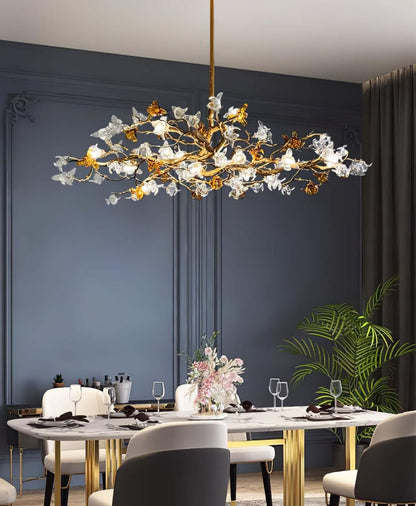 Aosta brass glass branch chandelier by korewolamp featuring elegant brass arms and clear glass flower-shaped light fixtures.