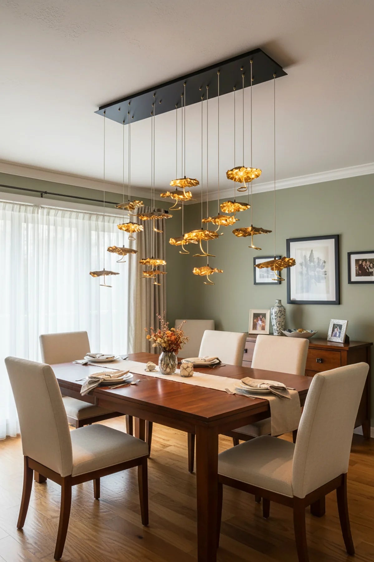 Brass aviary constellation chandelier by korewolamp featuring intricate bird and star-shaped metal design hanging from a sleek brass frame.