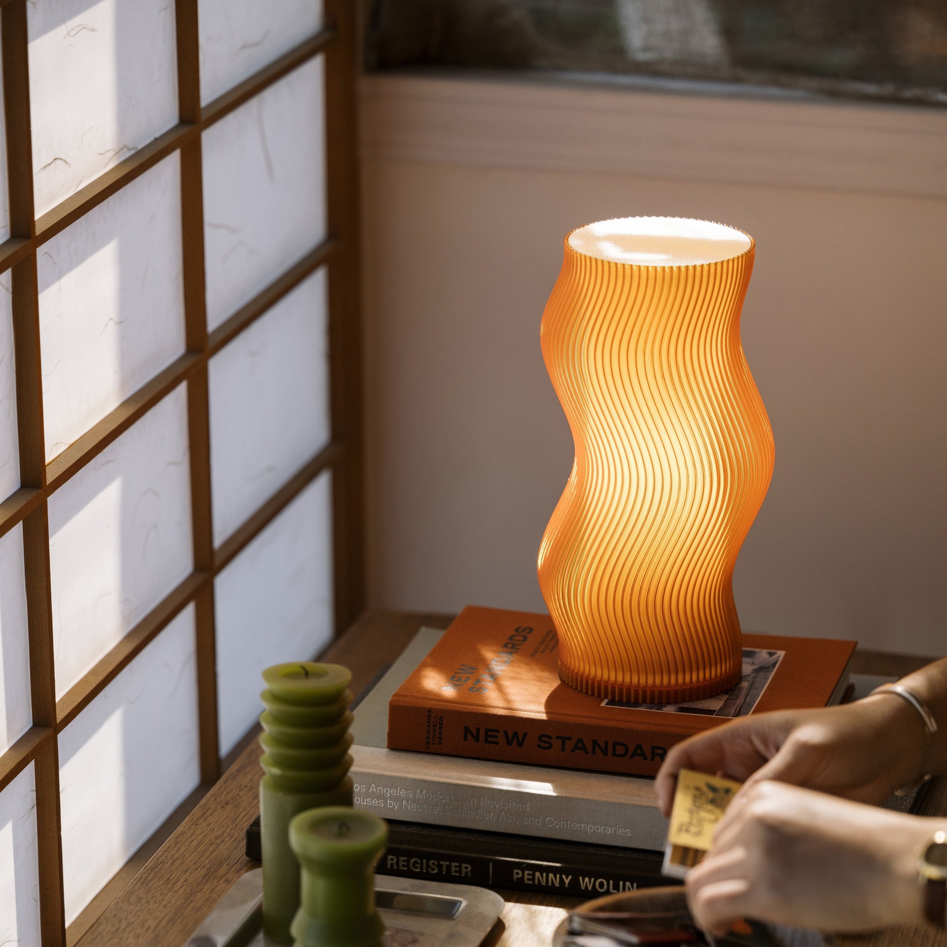 Terra Labs Woogie Table Lamp with a modern design, featuring a soft glowing light on a sleek base, ideal for home decor.