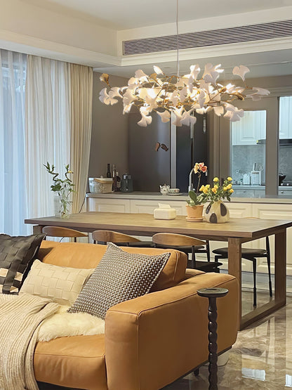 Korewolamp Gingko Ceramic Chandelier K hanging with multiple white ceramic leaf-shaped shades and a sleek modern design.