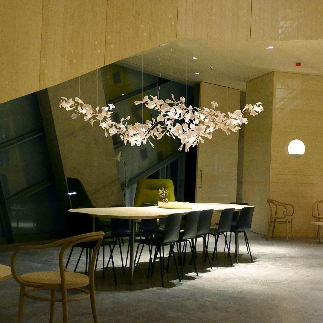Gingko Ceramic Chandelier by korewolamp featuring a modern design with ginkgo leaf-shaped ceramic shades hanging from a sleek frame