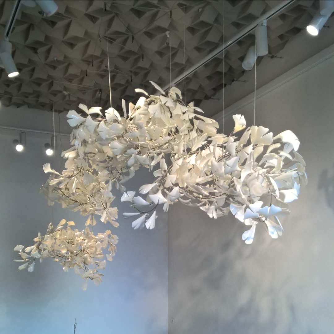 Korewolamp Gingko Ceramic Chandelier C featuring a modern design with ginkgo leaf-shaped ceramic shades hanging from a sleek metal frame.