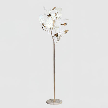 Korewolamp Gingko floor lamp with a sleek, modern design and a white lampshade standing on a wooden base in a stylish living room setting.