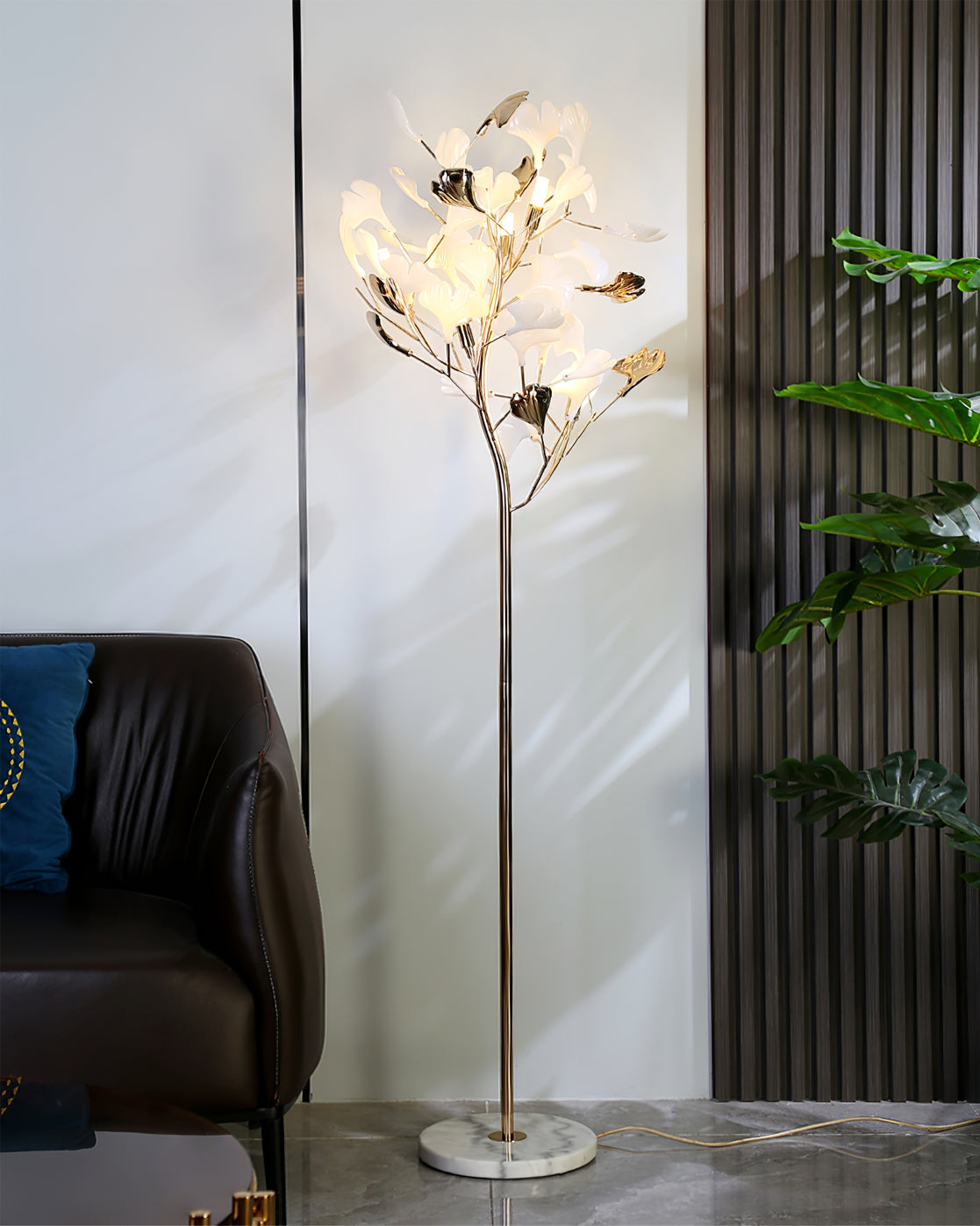 Korewolamp Gingko floor lamp with a sleek, modern design featuring a tall stand and a leafy-shaped lampshade.