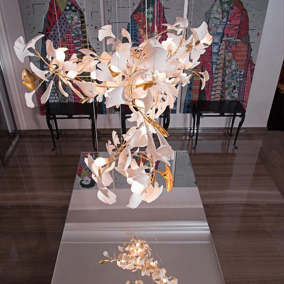 Gingko ceramic chandelier by Korewolamp featuring leaf-shaped design with white ceramic leaves and warm lighting.