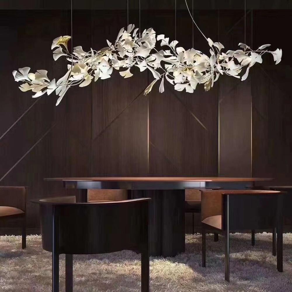 Ginkgo ceramic chandelier by Korewolamp featuring leaf-shaped design and warm lighting, hanging from a ceiling.