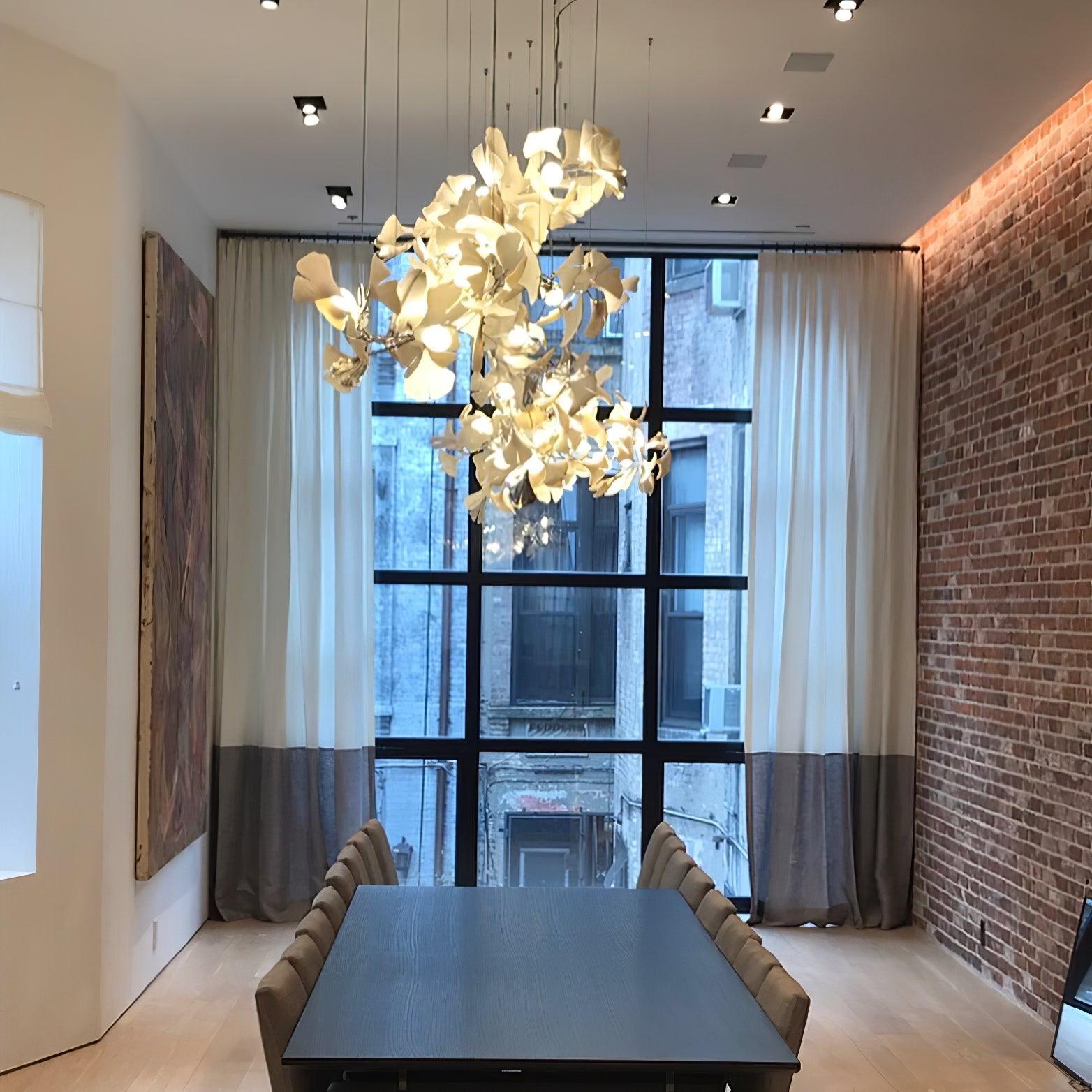Gingko Ceramic Chandelier by Korewolamp featuring leaf-shaped ceramic shades hanging with warm lighting.