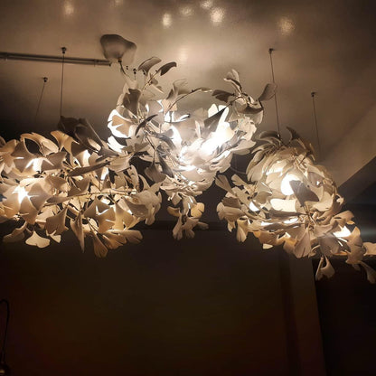 Ginkgo ceramic chandelier by Korewolamp featuring leaf-shaped design with white ceramic leaves and warm lighting.