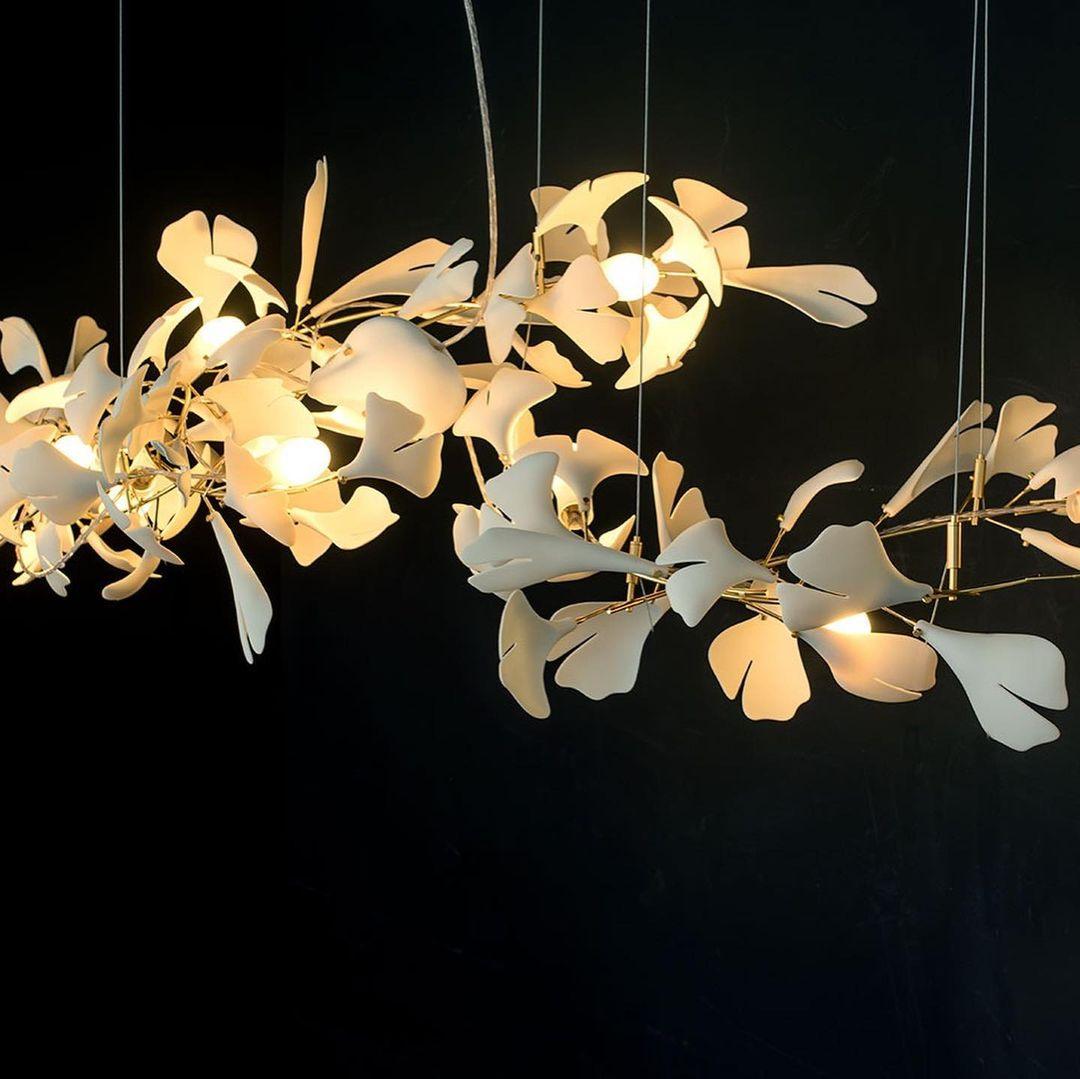 Gingko ceramic chandelier by korewolamp featuring ginkgo leaf design and warm ambient lighting in a modern interior setting.