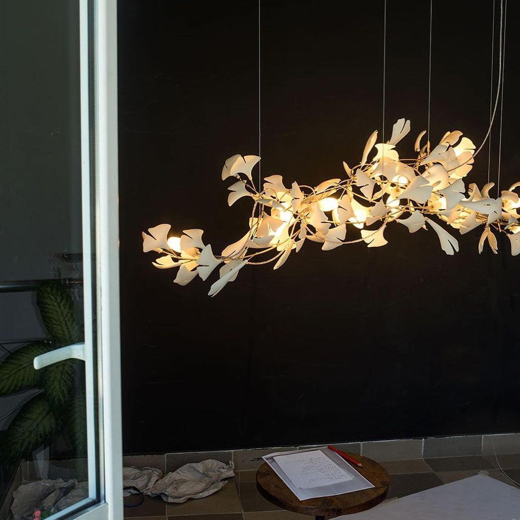 Gingko ceramic chandelier by Korewolamp featuring leaf-shaped ceramic design hanging from a metal frame.