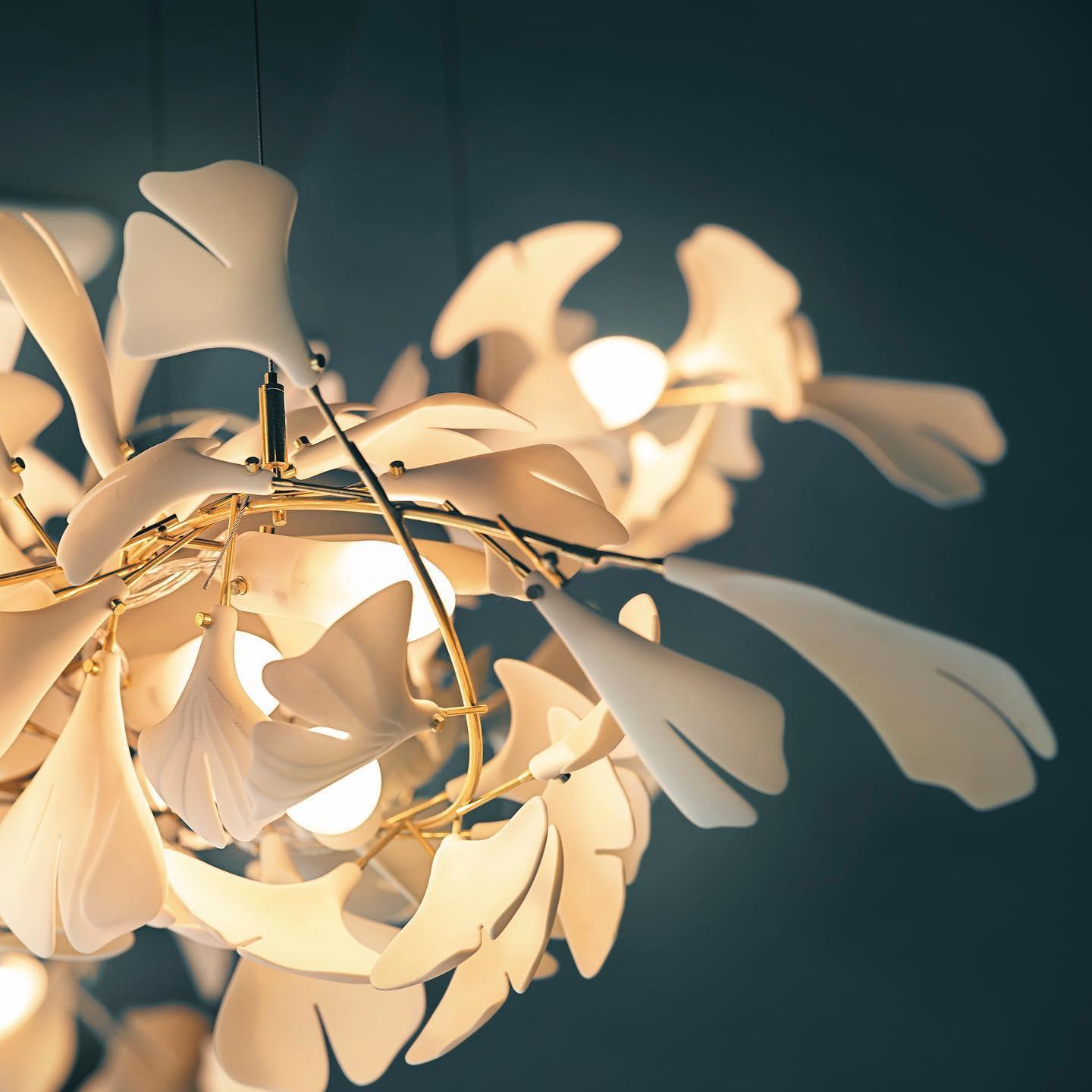 Gingko Ceramic Chandelier by Korewolamp featuring leaf-shaped ceramic design and warm ambient lighting.