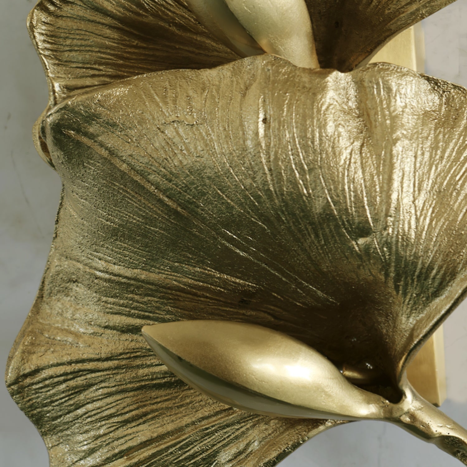 Korewolamp Ginkgo Leaf Wall Lamp with leaf-shaped design, warm lighting, mounted on a wall in a modern interior setting.