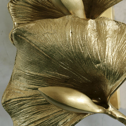 Korewolamp Ginkgo Leaf Wall Lamp with leaf-shaped design, warm lighting, mounted on a wall in a modern interior setting.