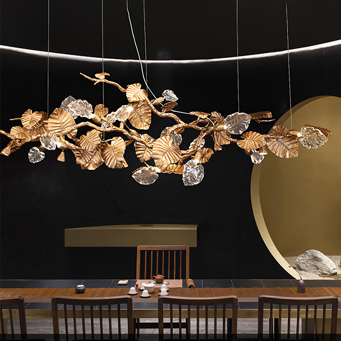 Gold Leaf Chandelier by korewolamp featuring intricate gold leaf detailing and multiple hanging light fixtures.