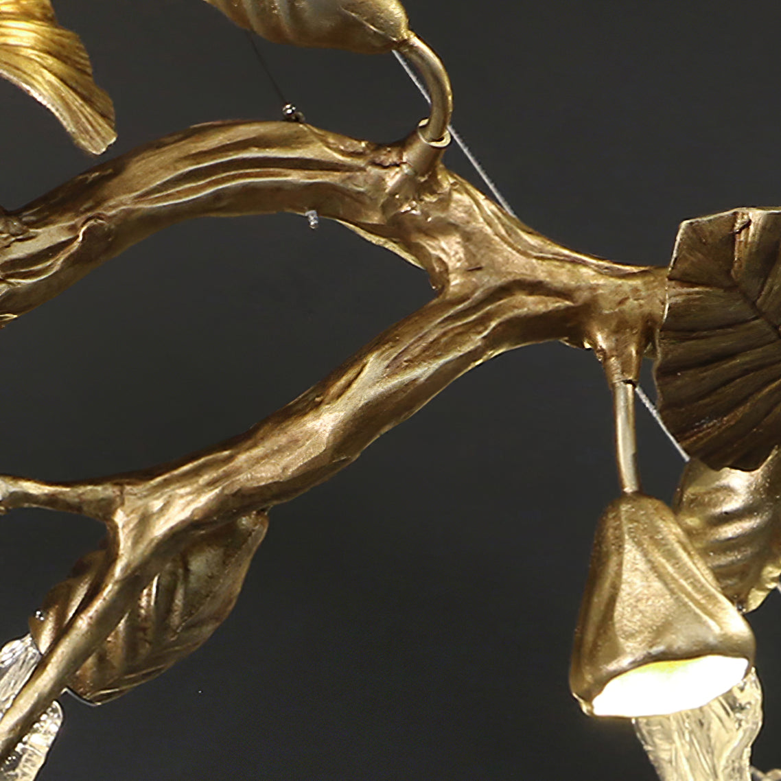Elegant gold leaf chandelier by Korewolamp with intricate design and multiple light fixtures hanging from a decorative frame.