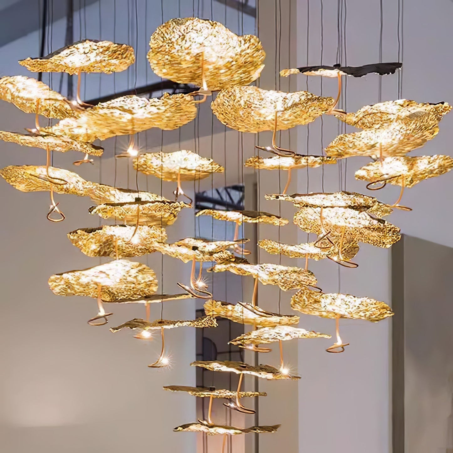 Gold brass aviary constellation chandelier by korewolamp with moon and star design, hangs as an elegant lighting fixture.