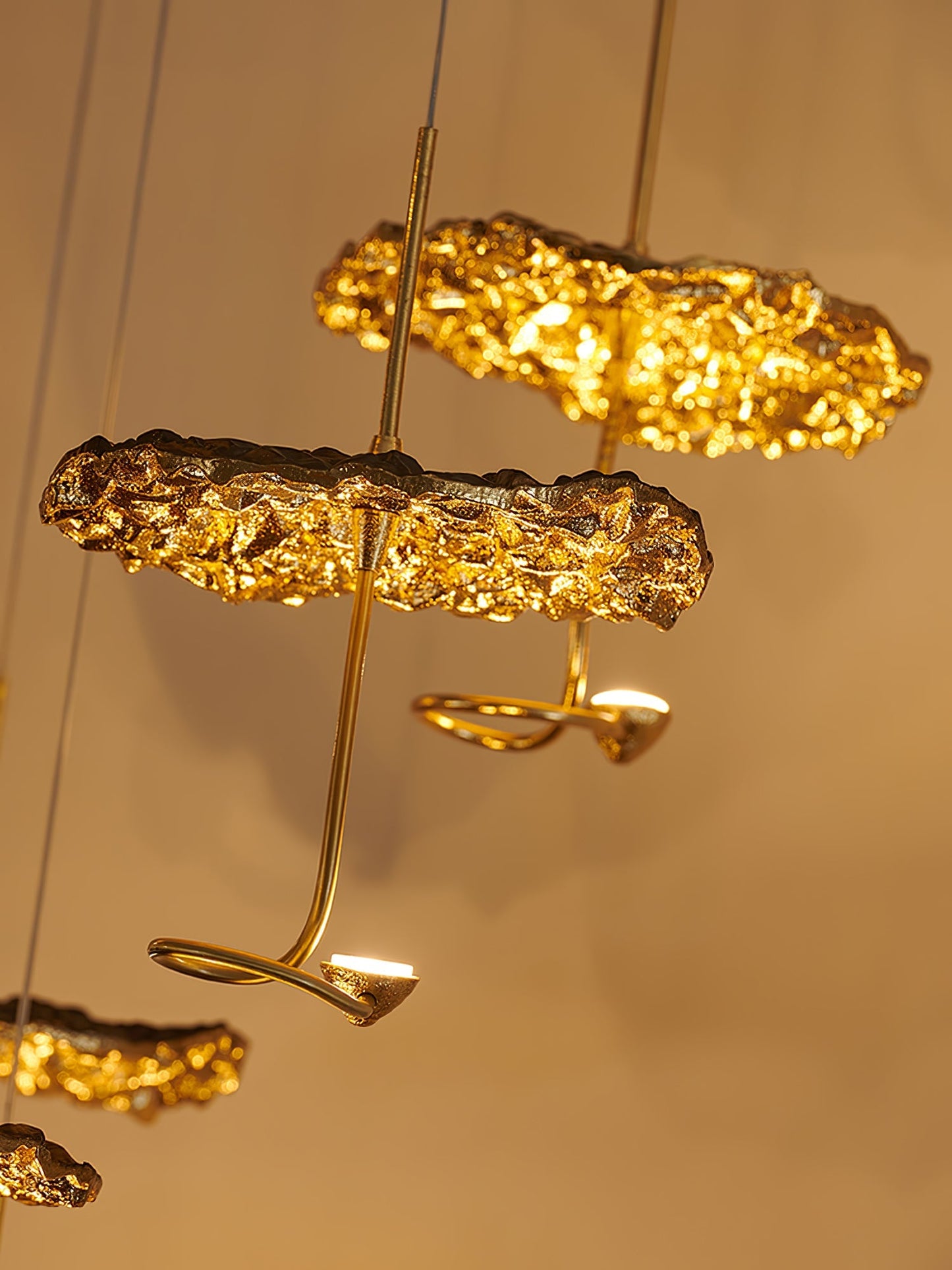 Gold brass aviary constellation chandelier with moon-shaped accents and intricate bird design, hanging with multiple branches.