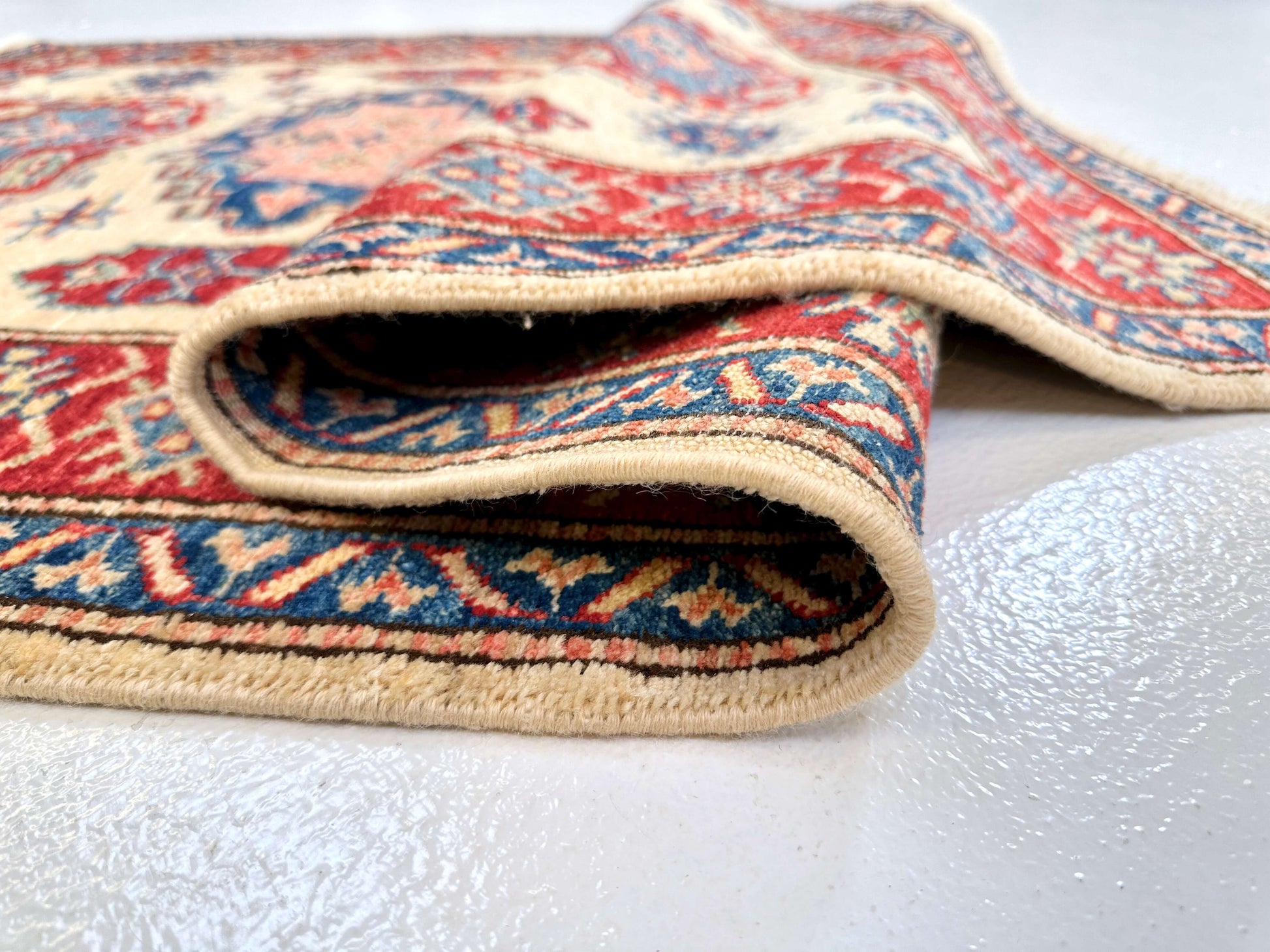 Kirishian Rugs Super Kazak 3'01" x 5'00" ivory and red woven rug with traditional geometric patterns.