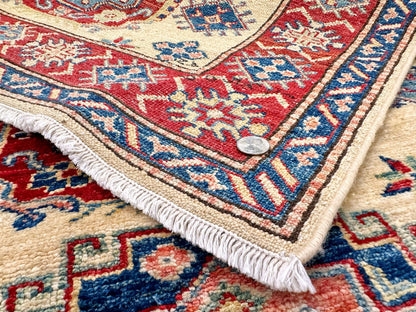 Kirishian Rugs Super Kazak rug, ivory and red, 3'01" x 5'00" with intricate traditional geometric patterns.