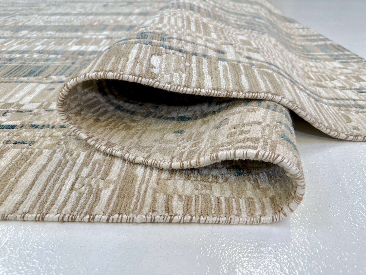 Contemporary Kirishian Rugs OneKind wool and bamboo area rug in gold, ivory, and teal with geometric pattern, 8x10 feet.