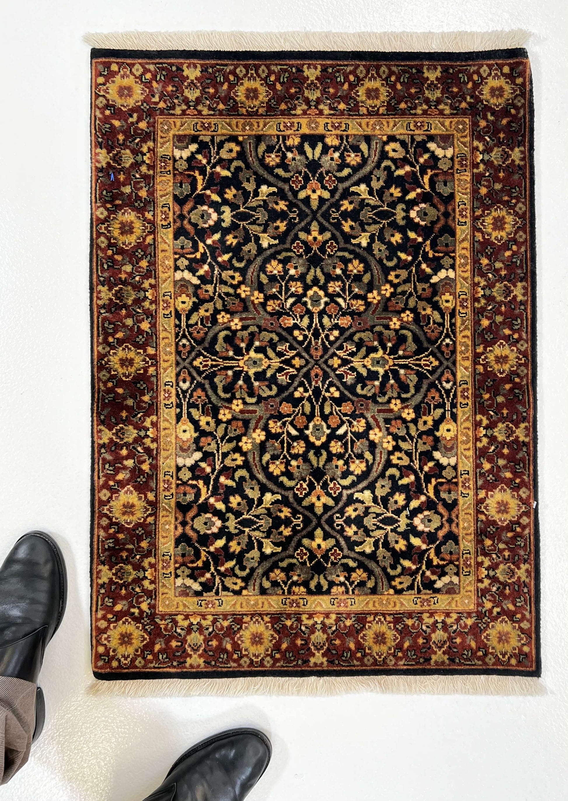 Kirishian Rugs IndoFarahan black and rust 2x3 fiber rug with geometric pattern on neutral background.