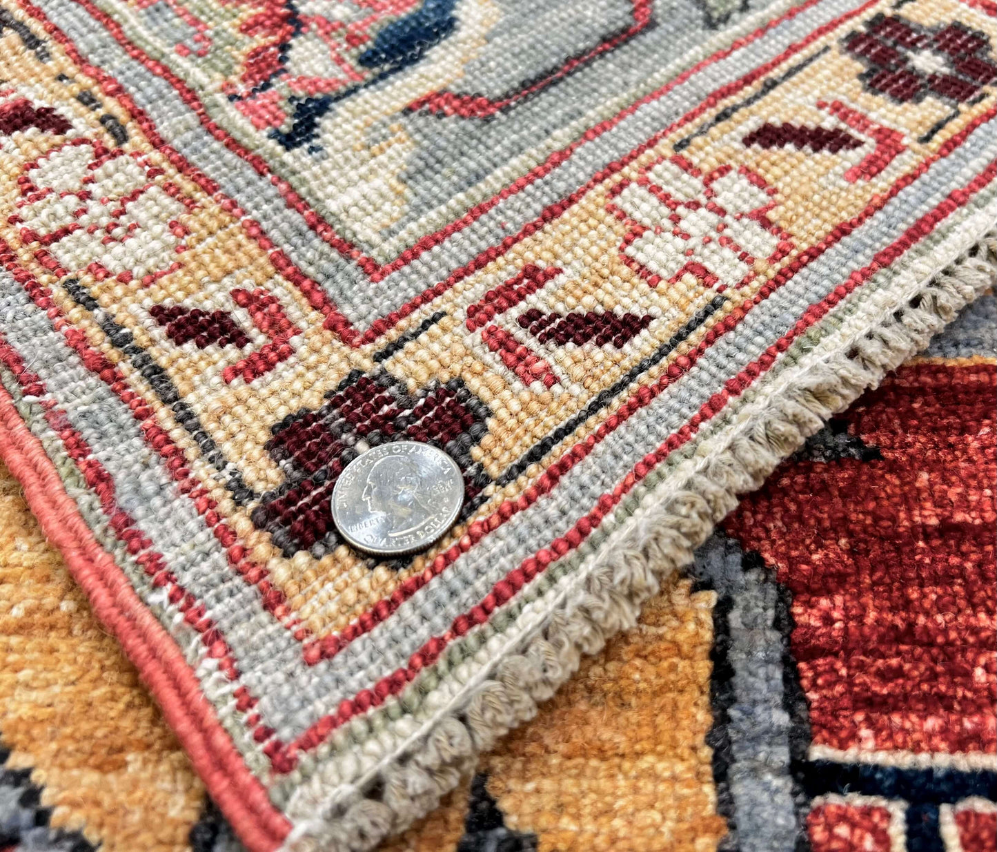 Afghan Heriz rug by Kirishian Rugs, 9'07" x 13'09", light red and light blue geometric design, detailed close-up of intricate patterns.
