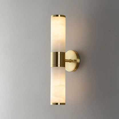 Alabaster Lampatron cylindrical wall lamp by Korewolamp with a sleek marble finish, mounted on a wall for ambient lighting.