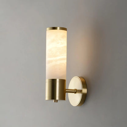 Alabaster Lampatron cylindrical wall lamp by korewolamp hanging on a wall, showcasing its smooth alabaster finish and modern design.