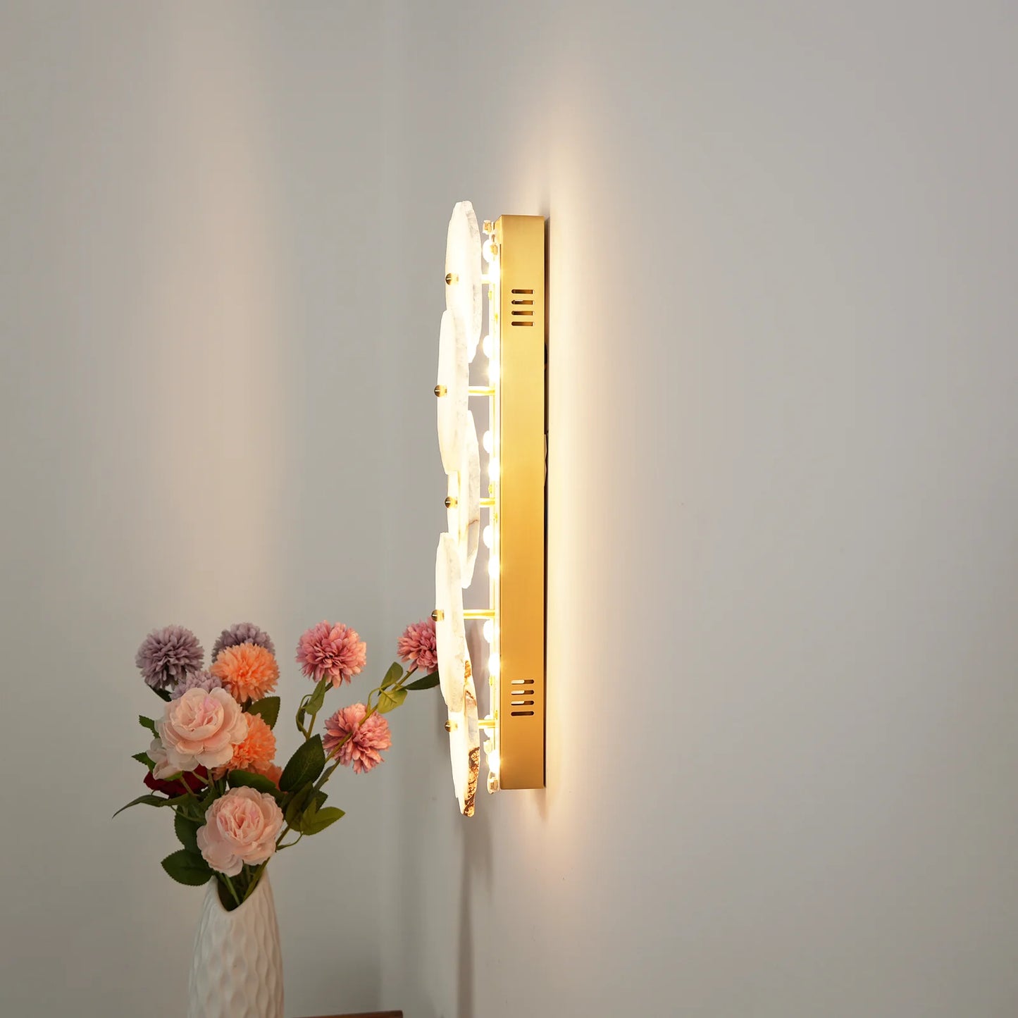 Korewolamp Petra wall lamp with sleek modern design and metallic finish, mounted on a wall with soft ambient lighting