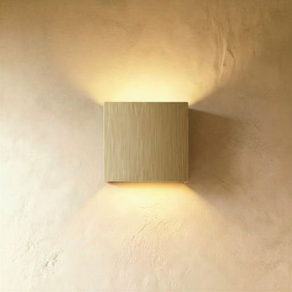 Brushed gold Lior Wall Lamp by Residence Supply mounted on a wall, showcasing its modern design and sleek finish.