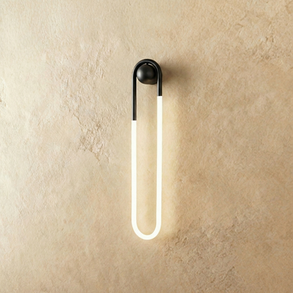 Black Zenn Wall Lamp by Residence Supply mounted on a plain background, featuring a sleek modern design with an 18W light bulb.