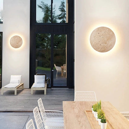Yellow travertine round wall lamp by Korewolamp, showcasing a smooth stone surface and sleek wall-mounted design.