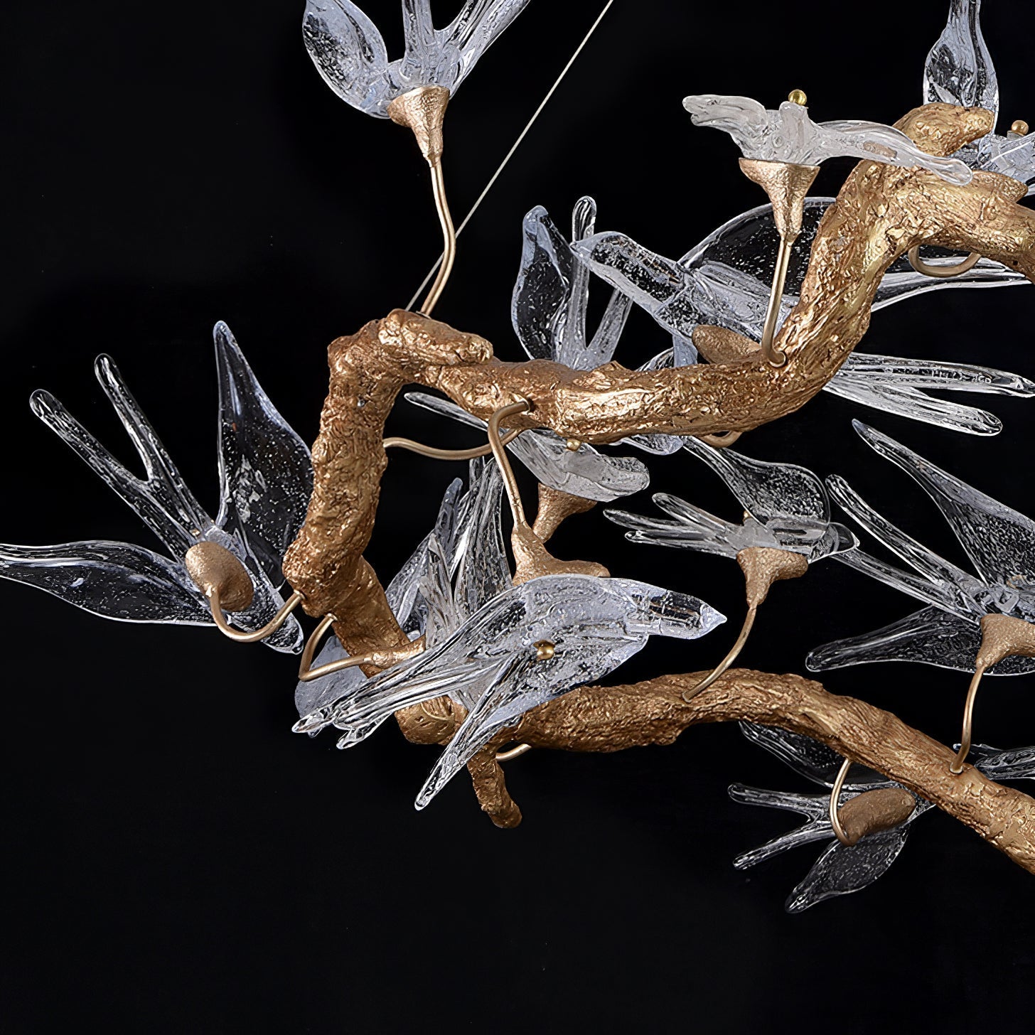 Korewolamp glass swallow chandelier with delicate glass bird-shaped ornaments hanging from a sleek metal frame.