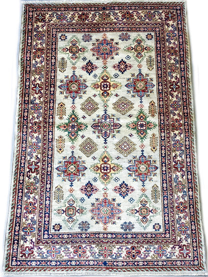 Kirishian Rugs Super Kazak ivory 4x6 closeout rug with intricate geometric patterns on a beige background, close-up view.